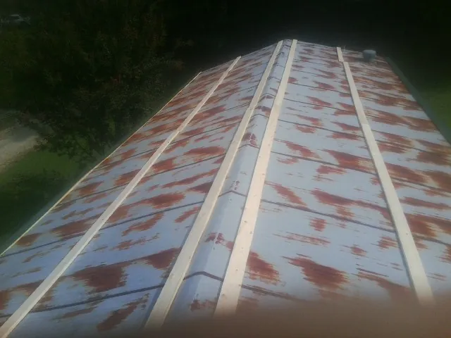 Rusted metal roof panels with new wood purlins before replacement — Storm Damage Roof Repair in Saint Simons Island by Roofing Brothers